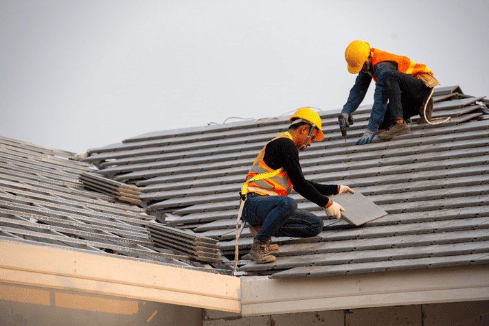 2 men working on roof